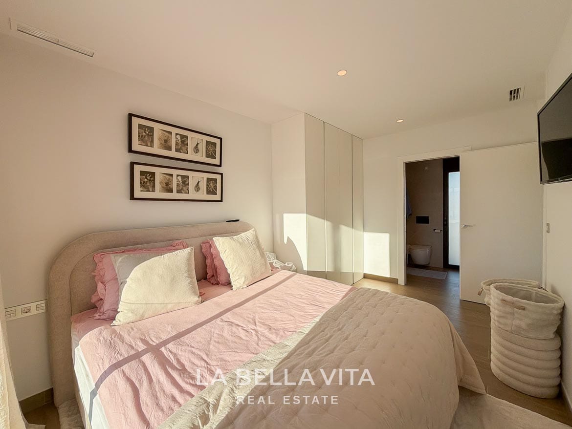 Modern Resale Villa with Basement and Private Pool for Sale in Finestrat-37 Double bedroom with fitted wardrobes and an open door to the en-suite bathroom in Finestrat, Alicante.