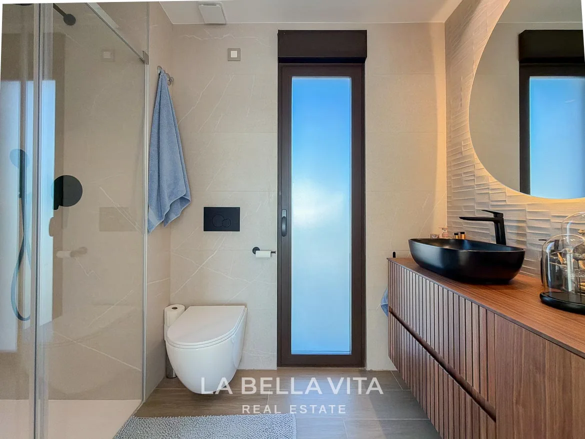 Modern Resale Villa with Basement and Private Pool for Sale in Finestrat-38 En-suite shower room with a wooden vanity, black basin and frosted window in Finestrat, Alicante.