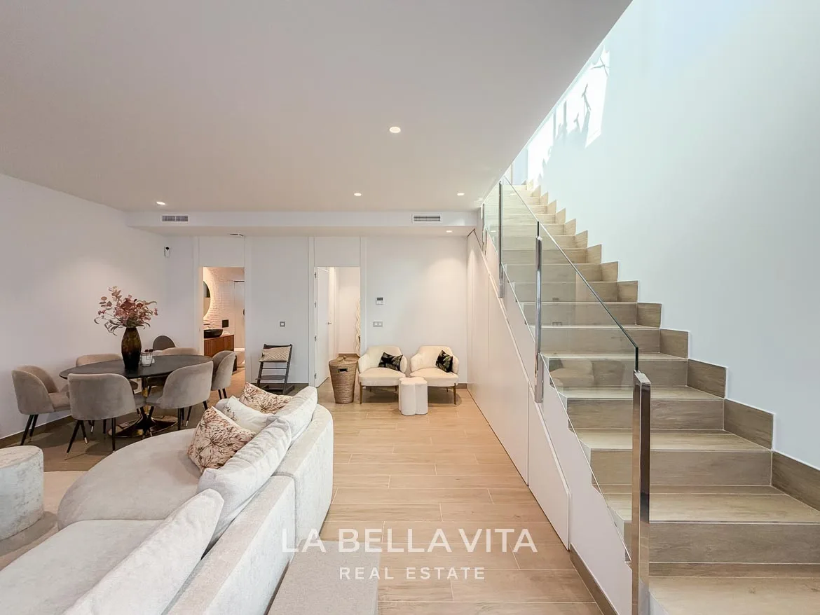 Modern Resale Villa with Basement and Private Pool for Sale in Finestrat-39 Basement living and dining area beside the glass-balustrade staircase in Finestrat, Alicante.