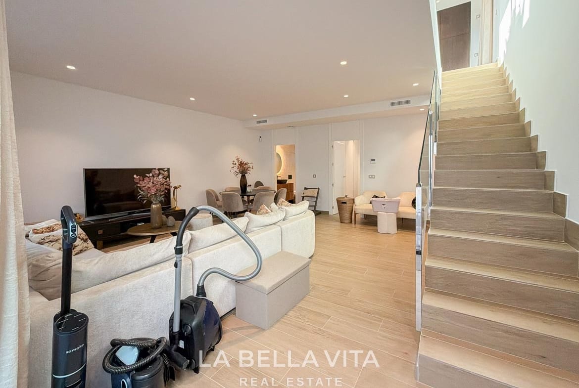 Basement lounge and dining space with the staircase leading to the floor above in Finestrat, Alicante.
