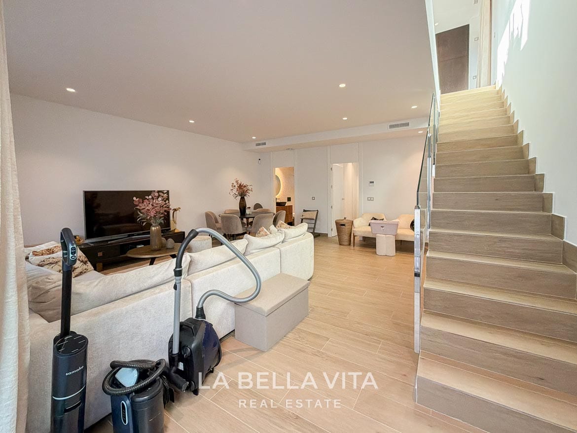 Modern Resale Villa with Basement and Private Pool for Sale in Finestrat-40 Basement lounge and dining space with the staircase leading to the floor above in Finestrat, Alicante.