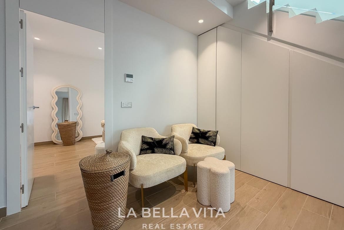 Pair of armchairs beside fitted under-stair storage in the basement in Finestrat, Alicante.