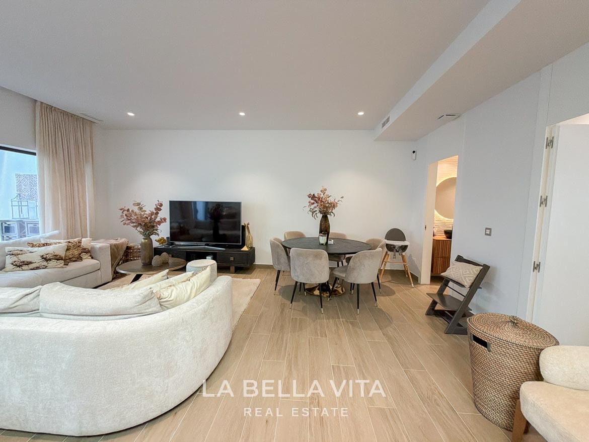 Modern Resale Villa with Basement and Private Pool for Sale in Finestrat-48 Basement lounge with a television and dining table beside the bathroom entrance in Finestrat, Alicante.