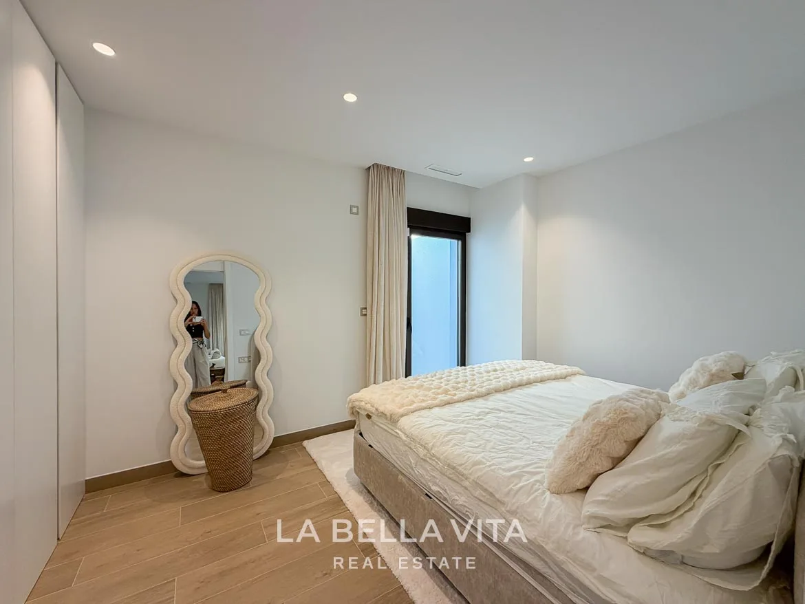 Modern Resale Villa with Basement and Private Pool for Sale in Finestrat-49 Basement double bedroom with fitted wardrobes and a full-length mirror in Finestrat, Alicante.