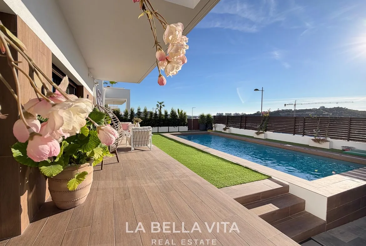 Poolside terrace with flowers and steps down to the parking area in Finestrat, Alicante.