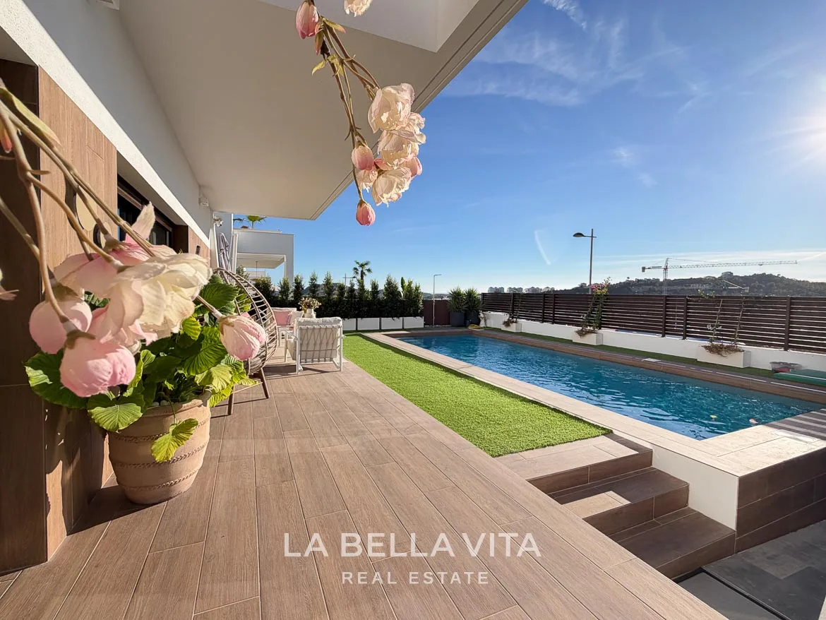 Modern Resale Villa with Basement and Private Pool for Sale in Finestrat-5 Poolside terrace with flowers and steps down to the parking area in Finestrat, Alicante.