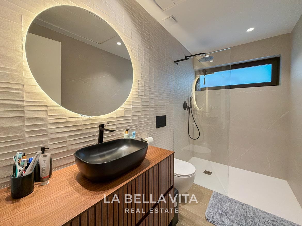 Modern Resale Villa with Basement and Private Pool for Sale in Finestrat-52 Basement bathroom with a black basin, illuminated mirror and glass shower screen in Finestrat, Alicante.