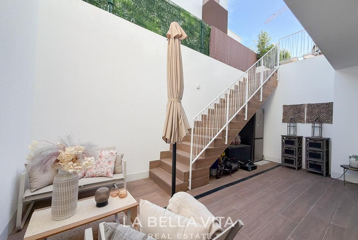 Sunken patio with outdoor seating and an external staircase to the garden in Finestrat, Alicante.