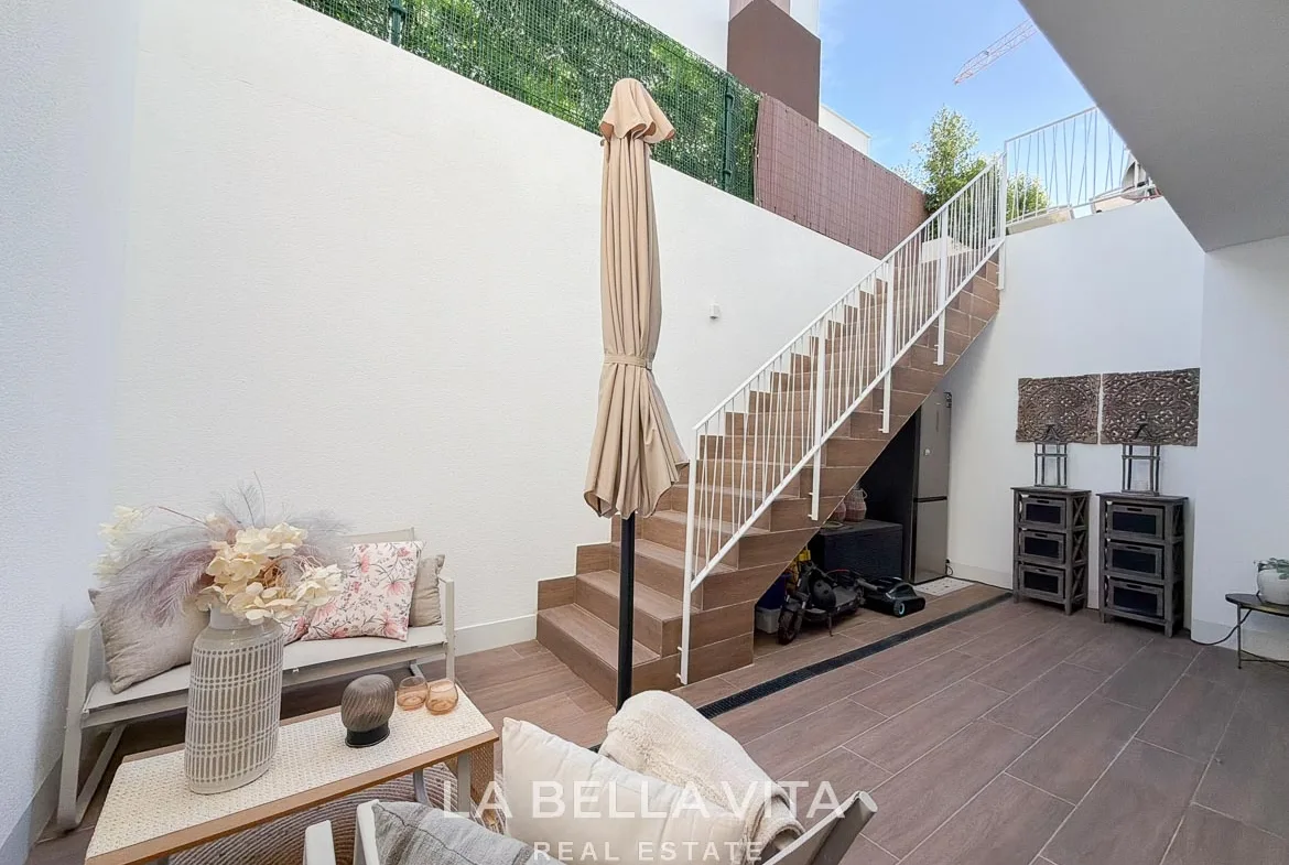 Sunken patio with outdoor seating and an external staircase to the garden in Finestrat, Alicante.