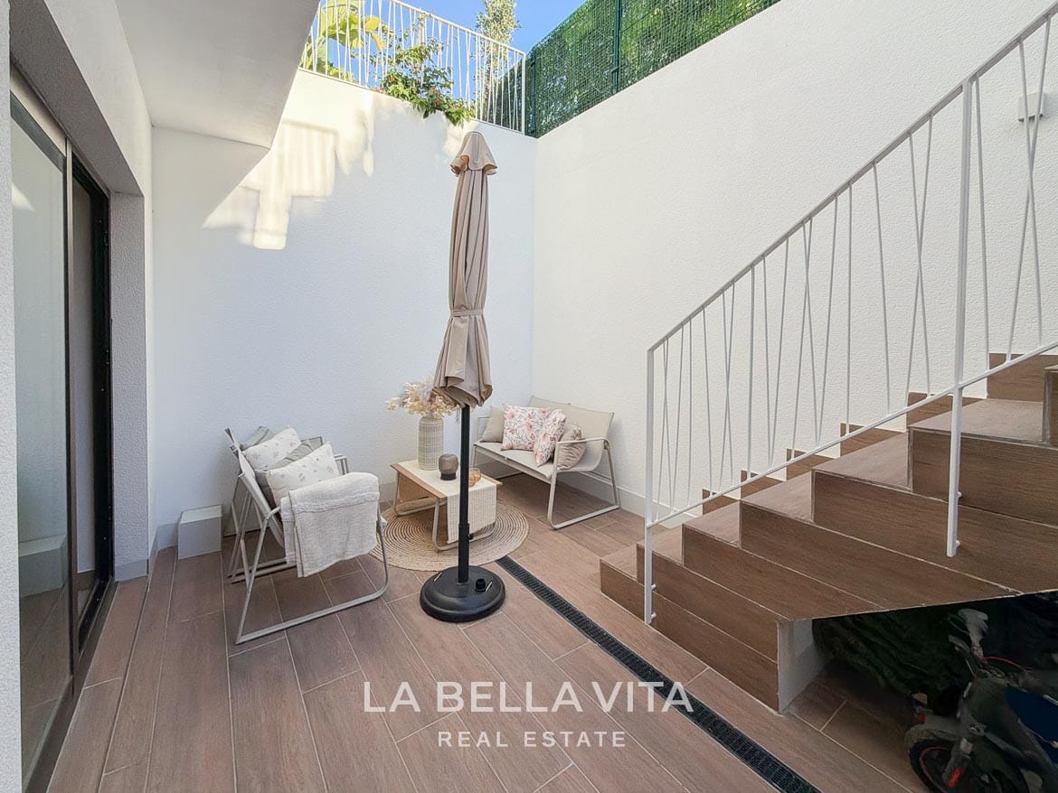 Modern Resale Villa with Basement and Private Pool for Sale in Finestrat-54 Basement patio seating beside the glazed doors and exterior stairs in Finestrat, Alicante.