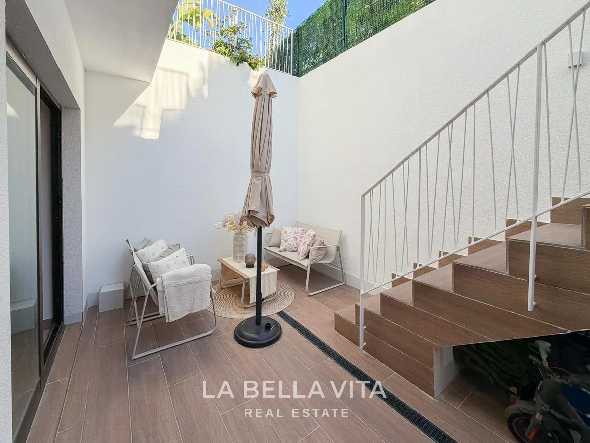 Modern Resale Villa with Basement and Private Pool for Sale in Finestrat-54 Basement patio seating beside the glazed doors and exterior stairs in Finestrat, Alicante.