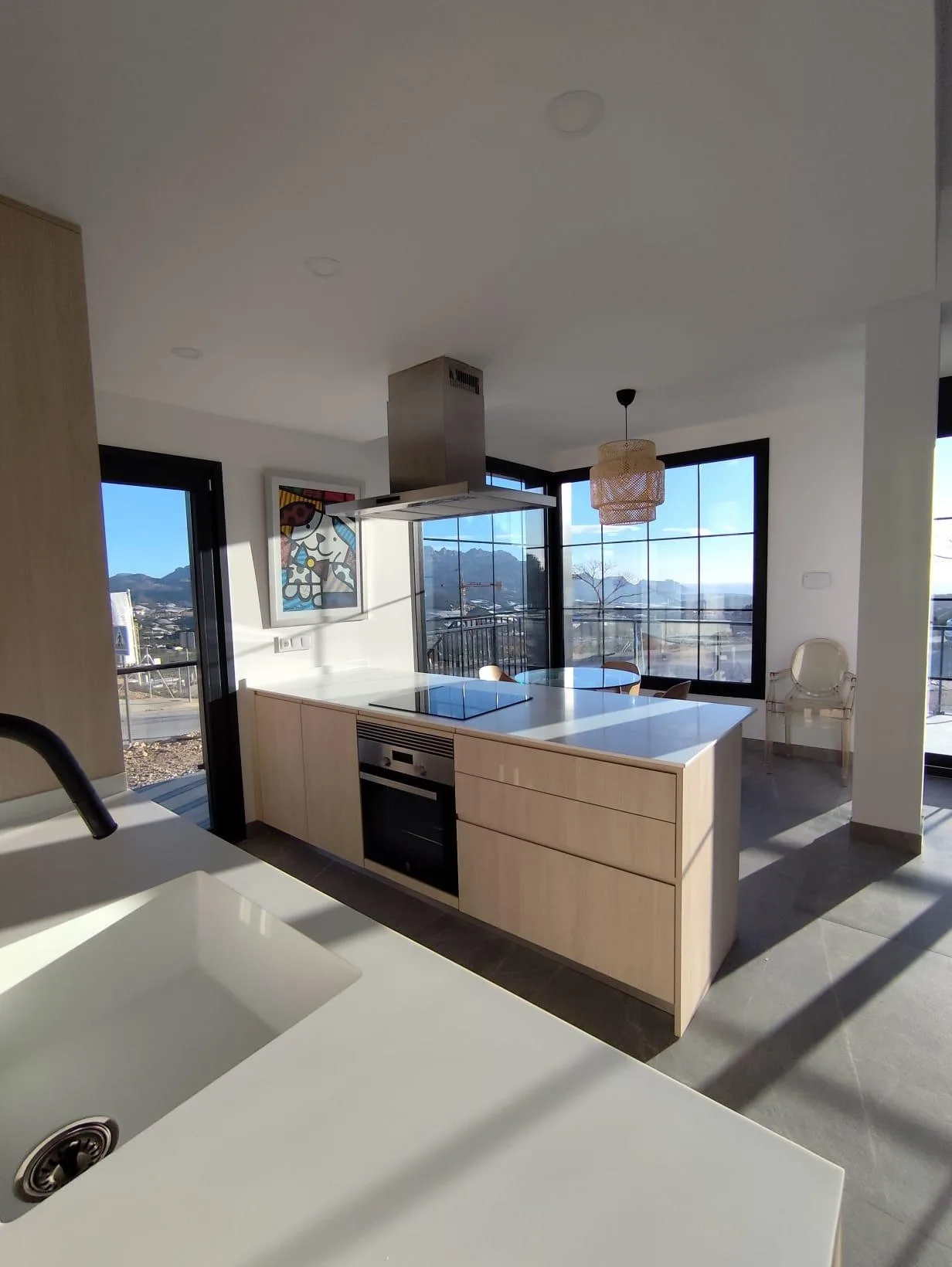 NEW-BUILD-SEMI-DETACHED-VILLAS-IN-POLOP-3 Kitchen with an island, oven and large windows in a Polop show home, Alicante