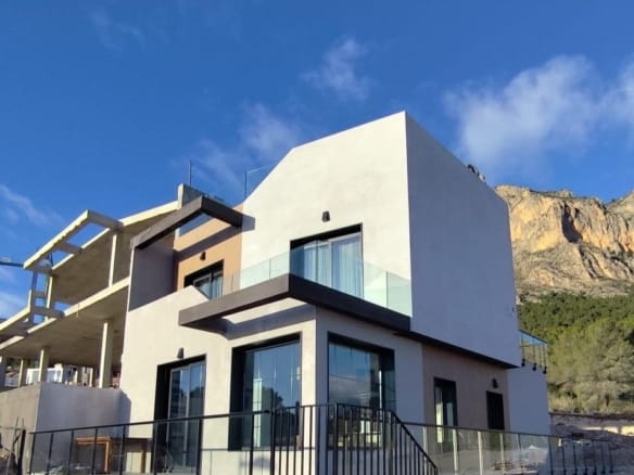 Exterior of a show home with terraces and mountain surroundings in Polop, Alicante
