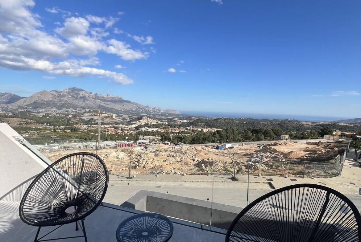 Outdoor seating on a show home terrace overlooking the landscape in Polop, Alicante