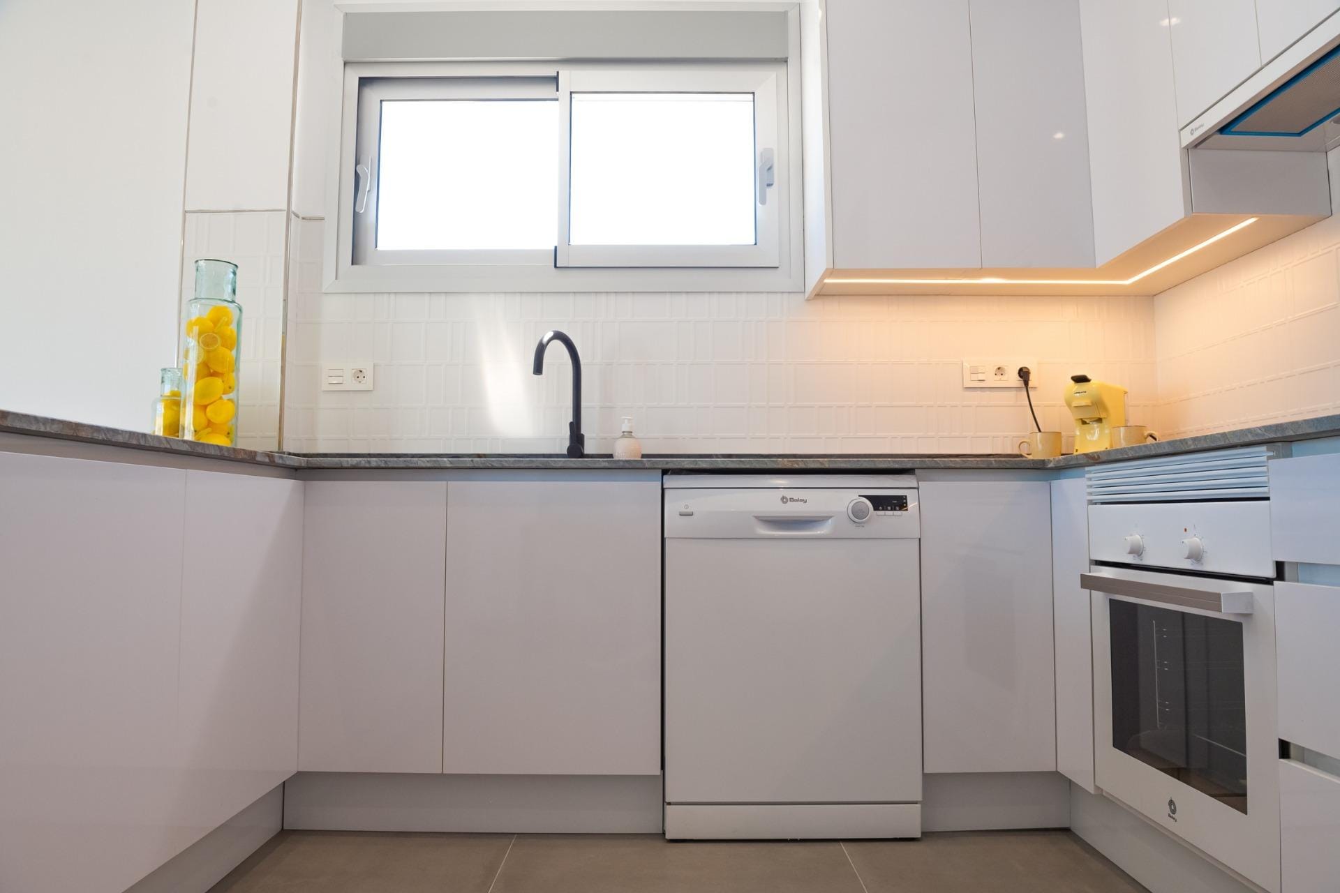 Kitchen with built-in appliances and a window above the sink in Torre del Rame, Los Alcázares, Murcia