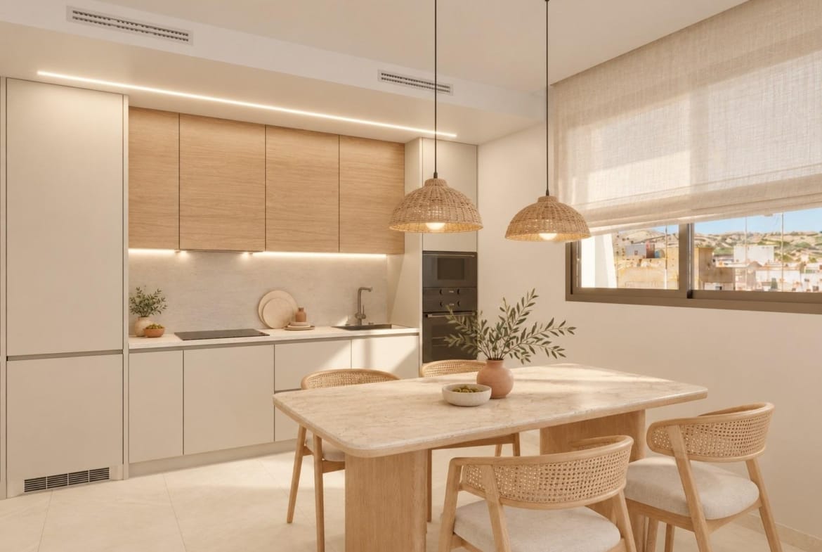 Apartment kitchen and dining area with white and timber cabinets in Santa Pola, Alicante
