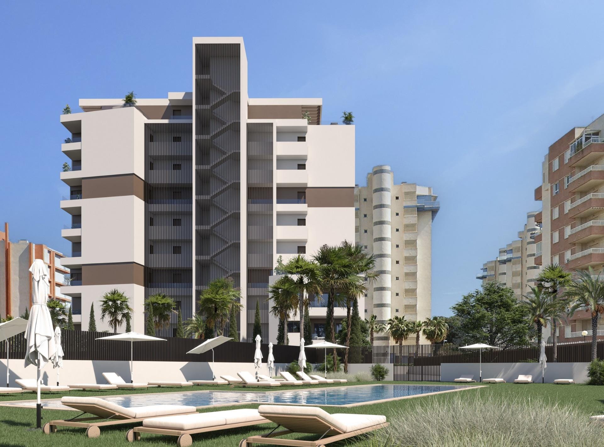 New Build Apartments in Guardamar del Segura Communal swimming pool with sunloungers and lawns beside a modern apartment building in Guardamar del Segura, Alicante