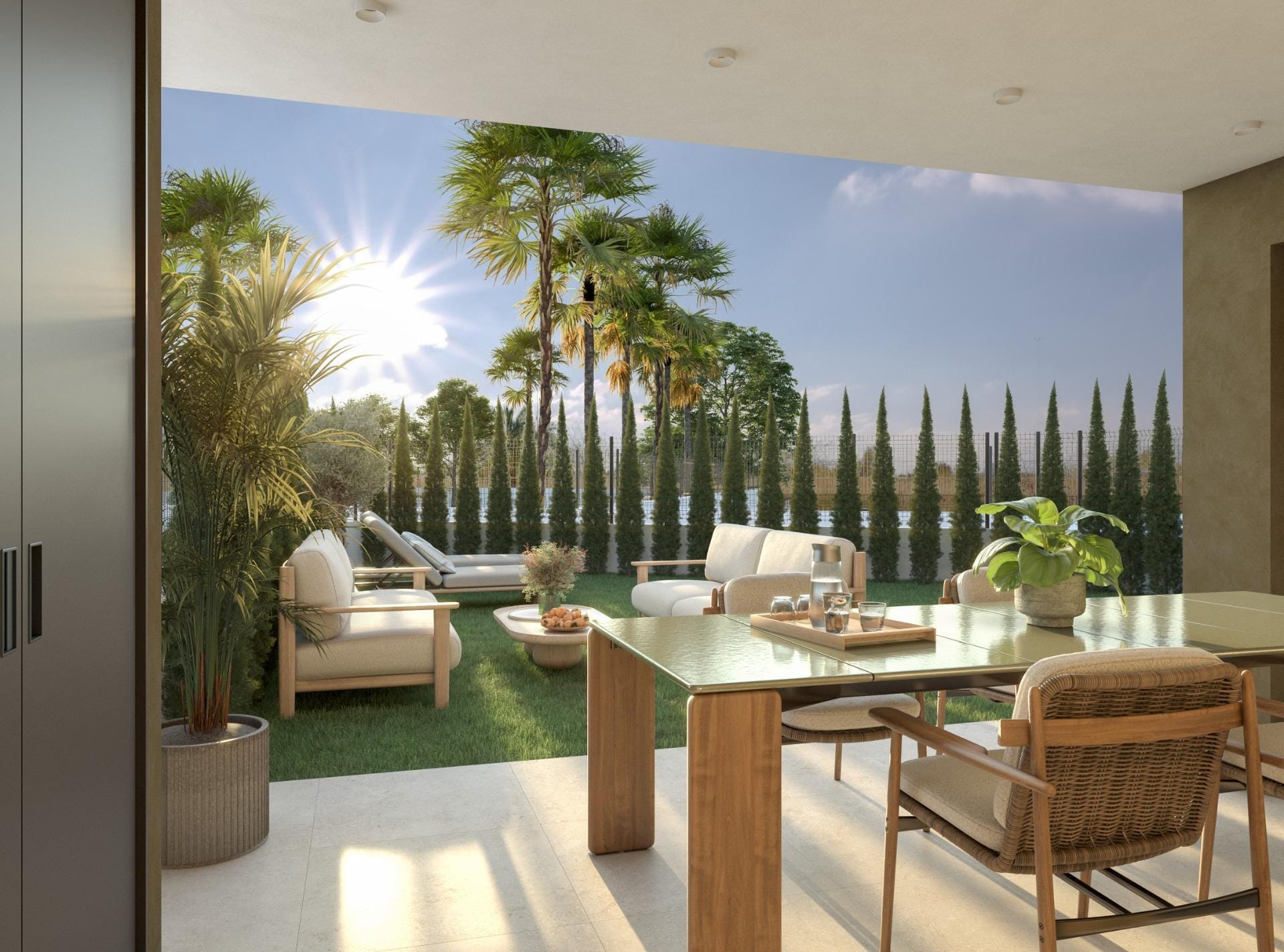 New-Build-Apartments-in-Guardamar-del-Segura-2 Covered dining terrace opening onto a garden with outdoor seating and palms in Guardamar del Segura, Alicante
