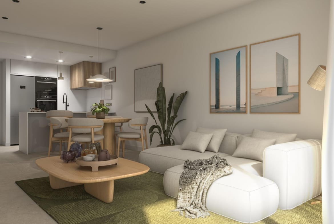Open-plan living room with a pale sofa, dining table and fitted kitchen in Guardamar del Segura, Alicante