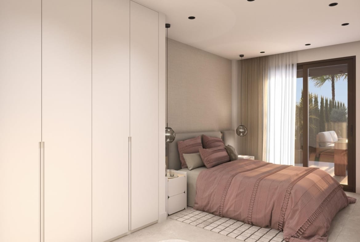 Bedroom with white wardrobes, rose-coloured bedding and glazed terrace doors in Guardamar del Segura, Alicante