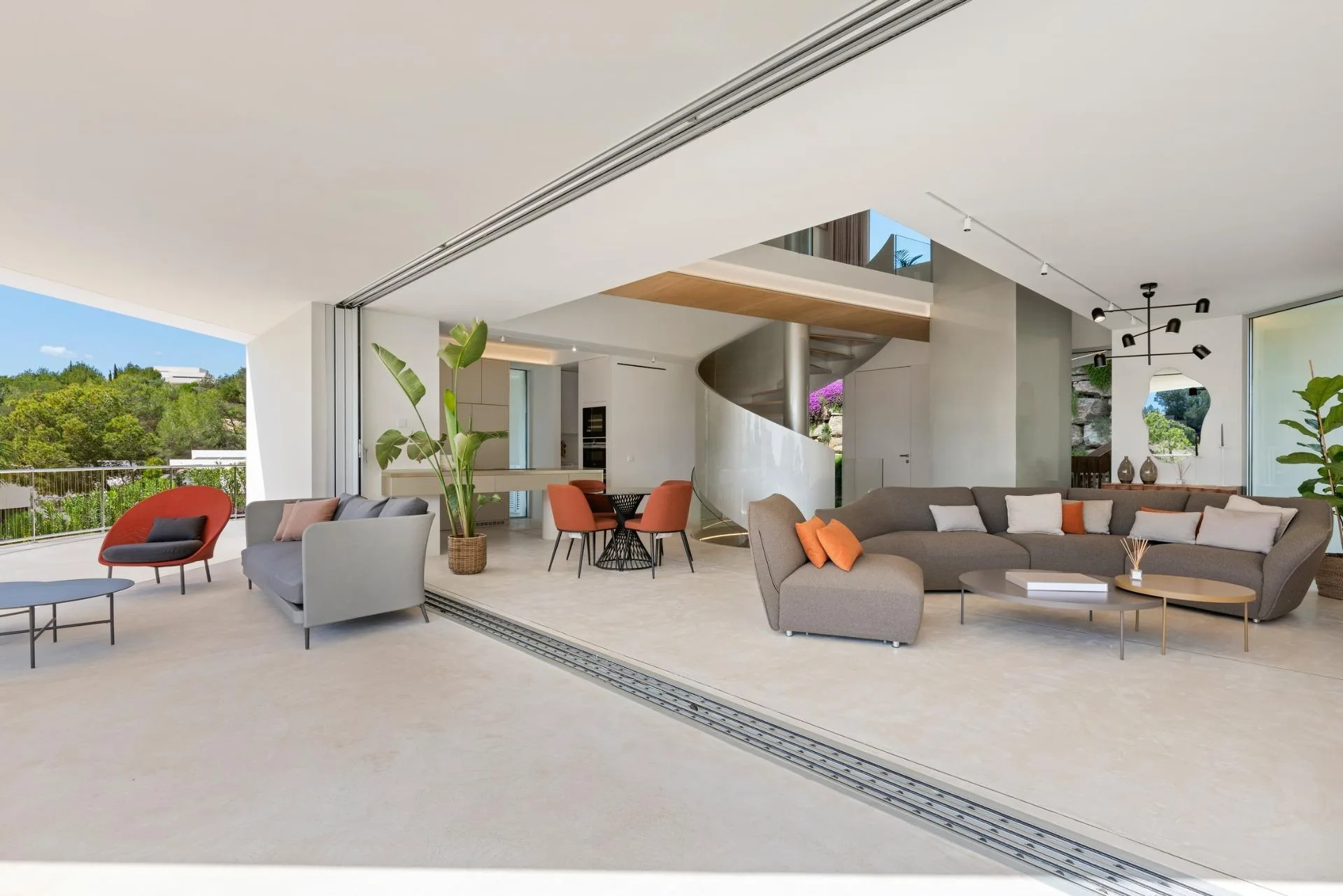 Light-filled living area with sliding glass doors opening onto a terrace at Las Colinas Golf and Country Club