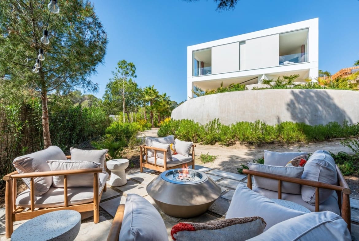 Outdoor seating area with fire pit beside a villa at Las Colinas Golf, Orihuela, Alicante