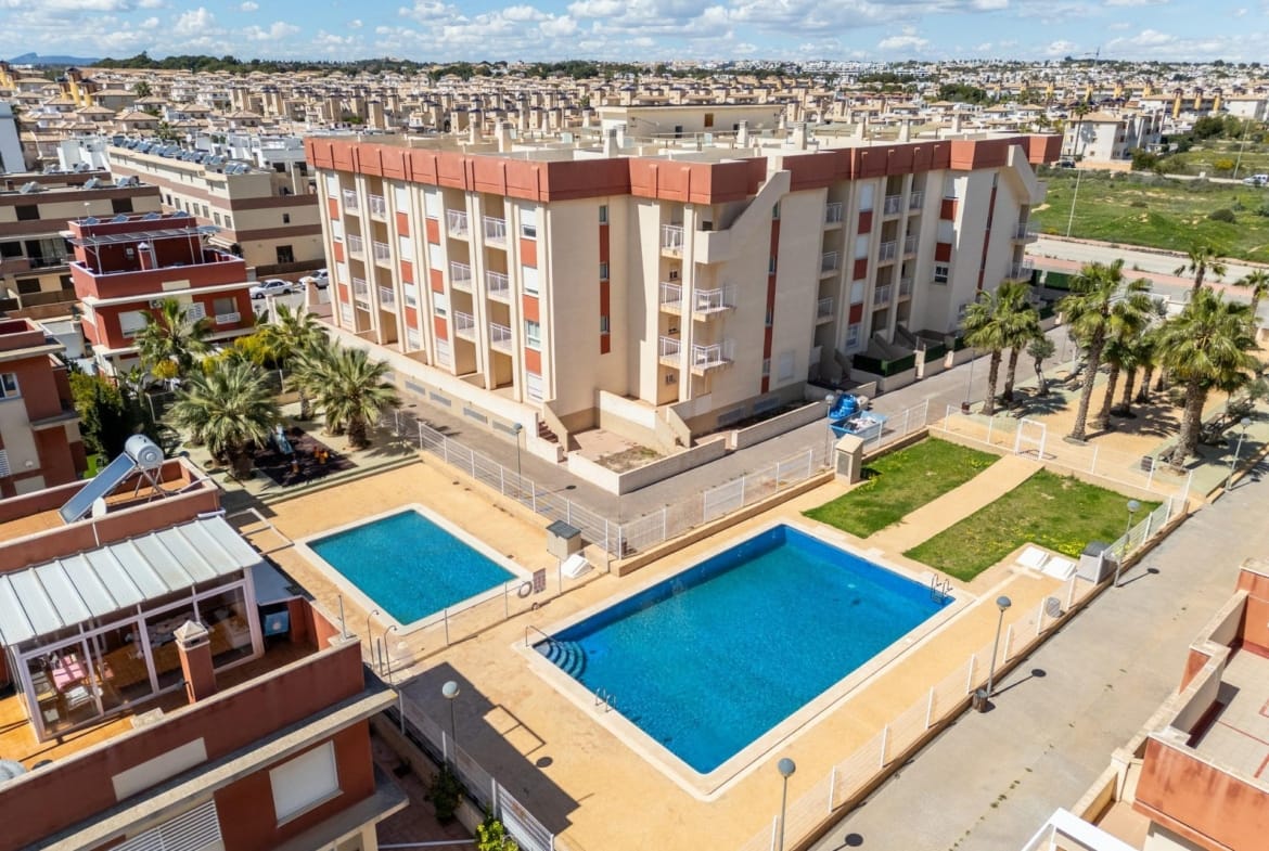 Communal pools and apartment balconies viewed from above in Lomas de Cabo Roig, Alicante
