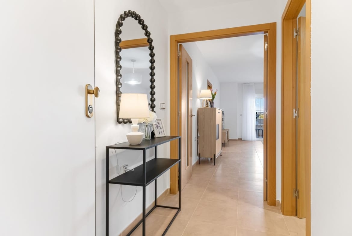 Entrance hall with a console table and mirror in Lomas de Cabo Roig, Alicante