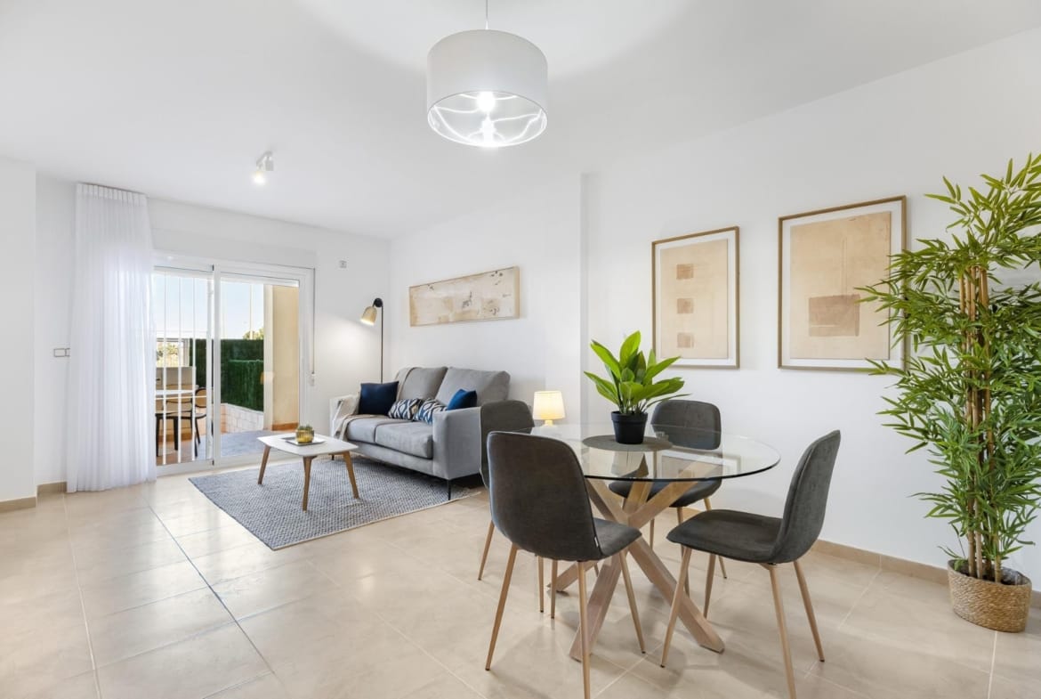 Furnished living and dining room with balcony doors in Lomas de Cabo Roig, Alicante