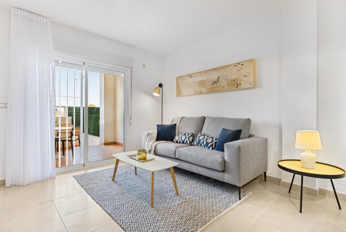 Living room with sofa and access to the terrace in Lomas de Cabo Roig, Alicante