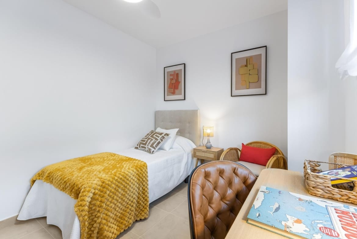 Twin beds with bedside table and framed artwork in Lomas de Cabo Roig, Alicante