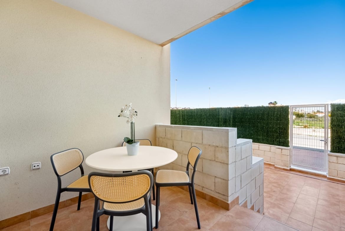 Covered terrace with round table and open outdoor area in Lomas de Cabo Roig, Alicante