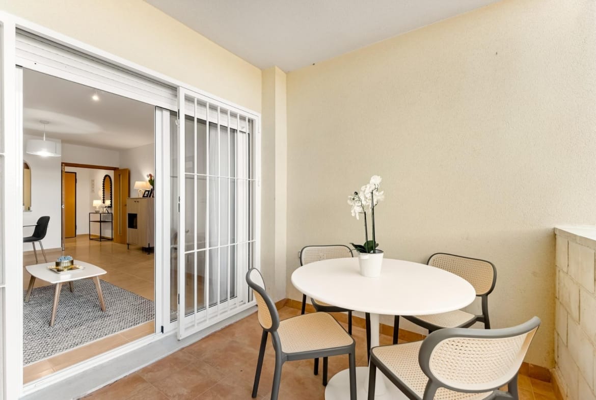Terrace dining table beside sliding glass doors in Lomas de Cabo Roig, Alicante