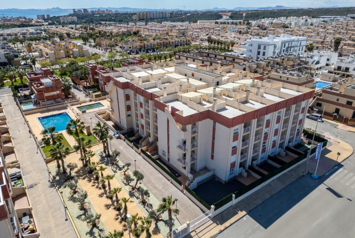 Aerial view of the residential buildings and pool area in Lomas de Cabo Roig, Alicante