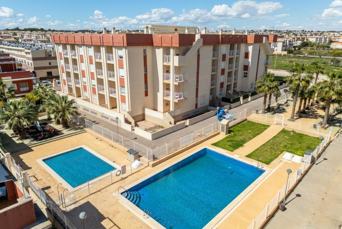 Aerial view of the communal pools and landscaped grounds in Lomas de Cabo Roig, Alicante