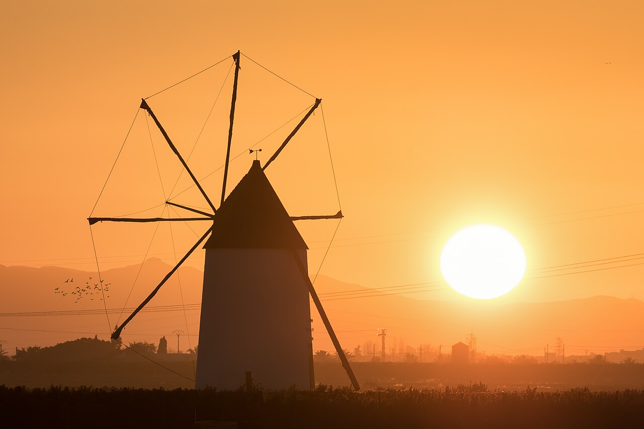 Traditional windmill silhouetted against a golden sunset near Torre Pacheco, Murcia
